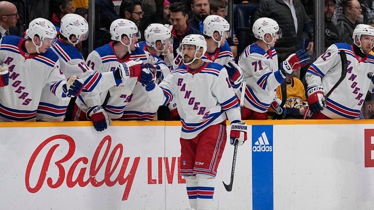 Rangers center Vincent Trocheck (16) celebrates a goal with teammates...