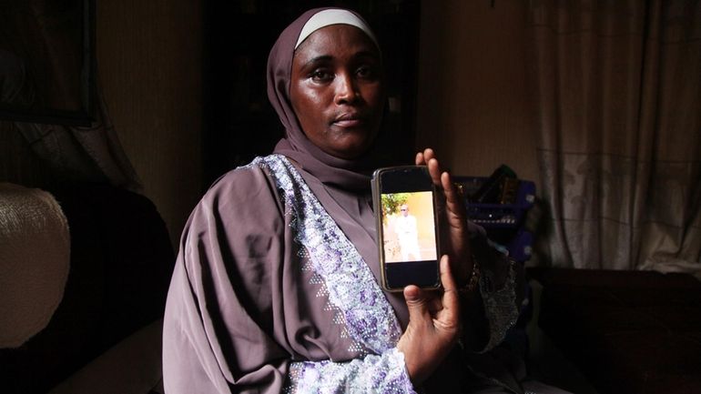 Kadidia Bocoum shows a picture of her brother Yeri Bocoum,...