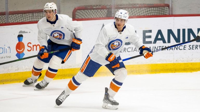 Bo Horvat, right, skates with Mathew Barzal at the Islanders'...