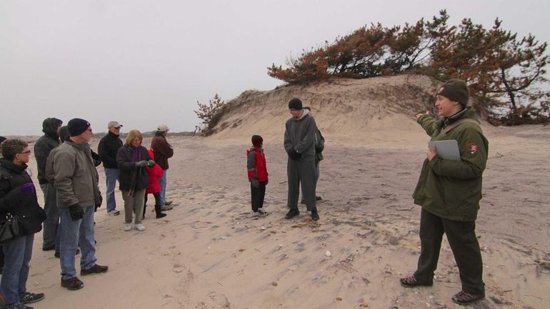 Park Ranger Ruth Coffey, right, talks to participants of a...