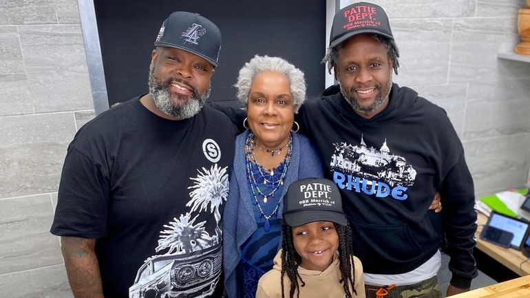 Jessie Byron is flanked by her sons, Parnell "Pops" Gervais, left,...