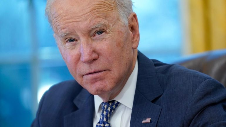 President Joe Biden participates in a briefing in the Oval...