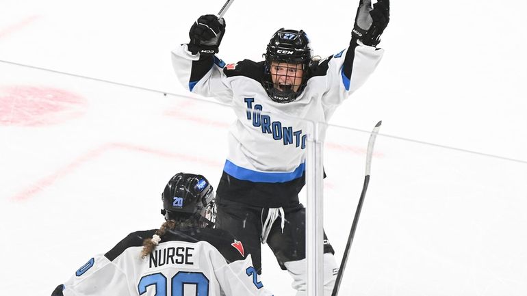 Toronto's Sarah Nurse (20) celebrates with teammate Emma Maltais (27)...