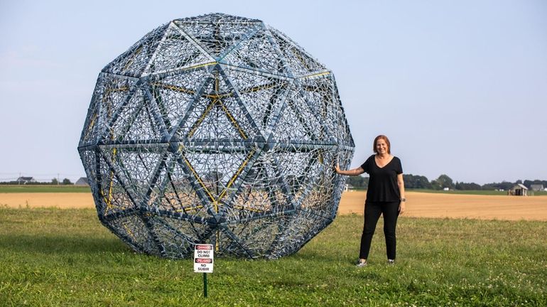 Artist Sherry Davis with her piece "Harvesting Memories in Blue" in...