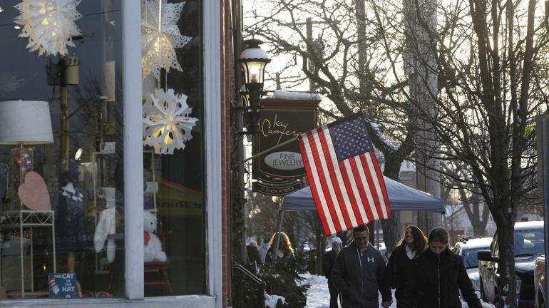 Walking along Main Street near Candee Avenue in Sayville on...