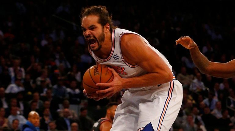 Joakim Noah of the Knicks grabs a rebound against the...