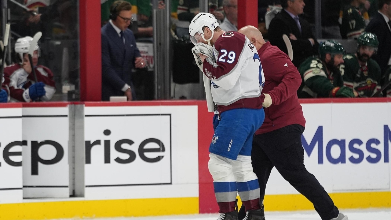 MacKinnon takes a puck from an Avs teammate to the face - Newsday