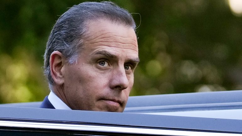 Hunter Biden steps into a vehicle as he leaves federal...