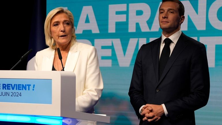 French far-right leader Marine Le Pen speaks as Jordan Bardella,...