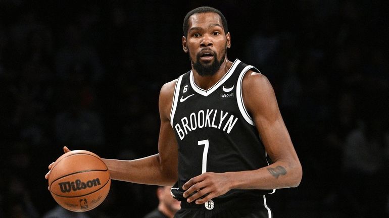 Nets forward Kevin Durant controls the ball against the Magic...