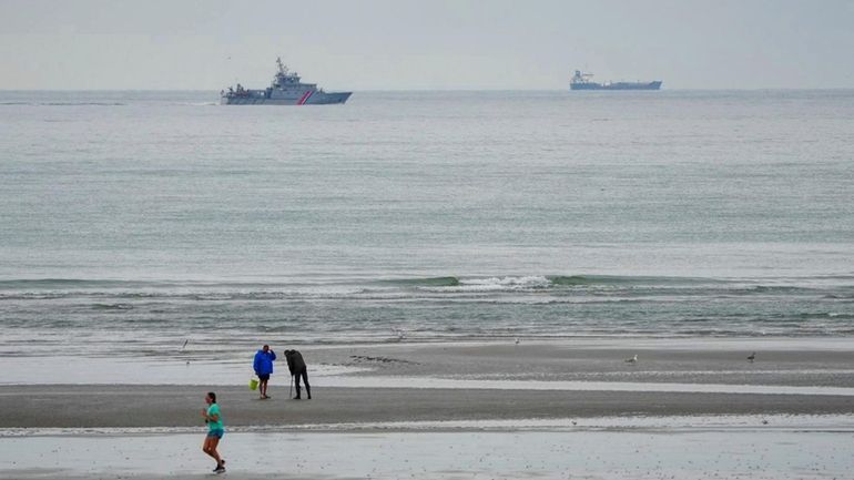 A vessel of the French Gendarmerie Nationale patrols in front...