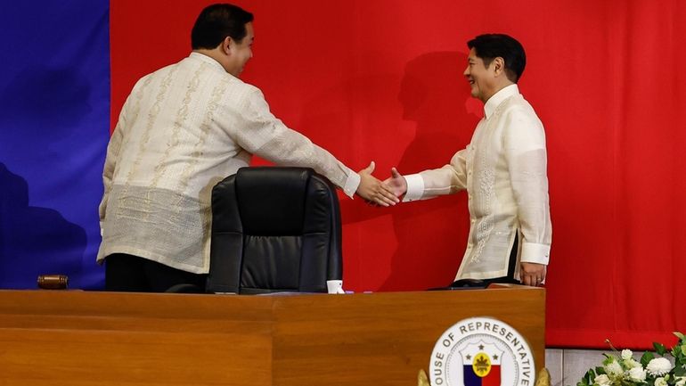 Philippines President Ferdinand Marcos Jr. right, shakes hands with House...