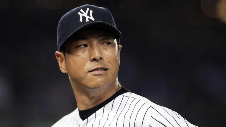 Hiroki Kuroda looks back after being struck by a batted...