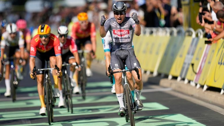 Belgium's Jasper Philipsen celebrates as he crosses the finish line...