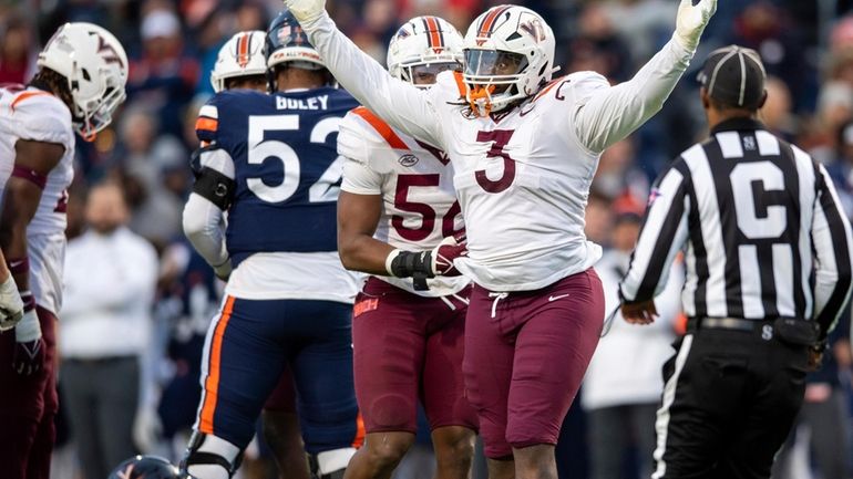 Virginia Tech defensive lineman Norell Pollard (3) celebrates after sacking...