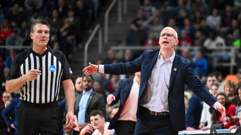 UConn head coach Dan Hurley, right, reacts after a play...