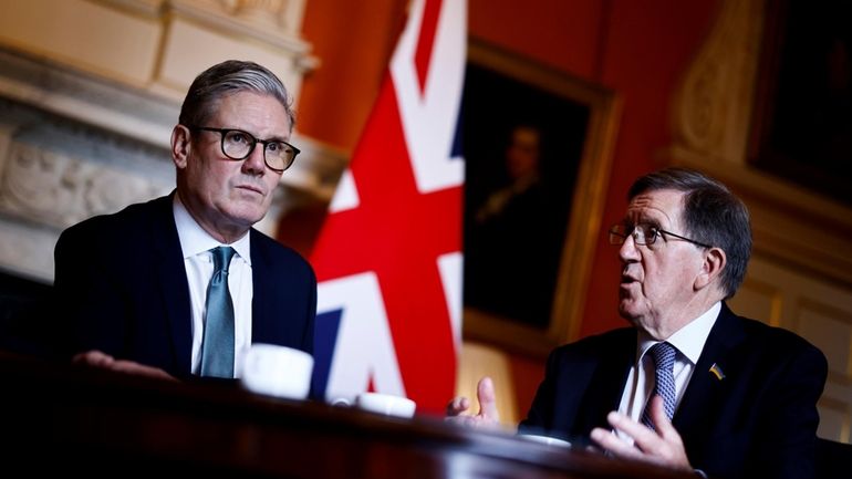 Britain's Prime Minister Keir Starmer listens to Member of the...