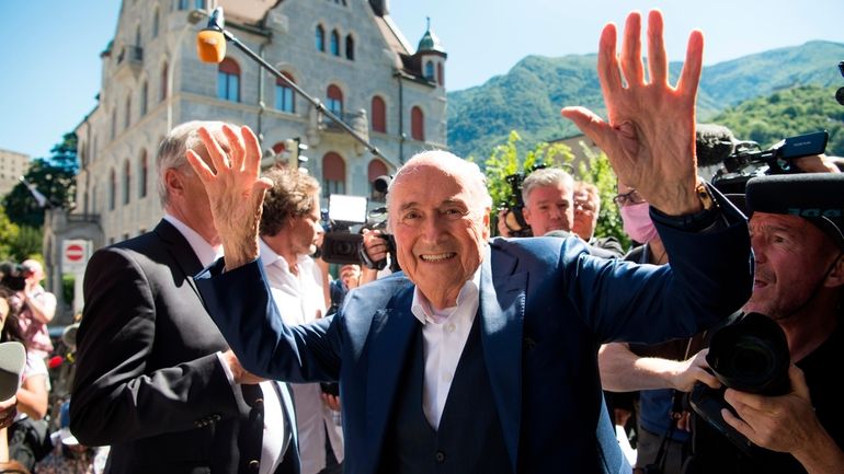 The former Fifa President, Joseph Blatter, center, surrounded by media...