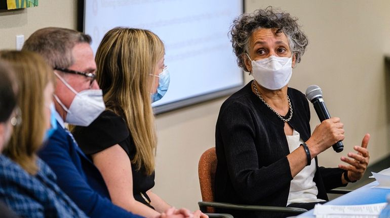 NYS Health Commissioner Mary T. Bassett, right, speaks to members...