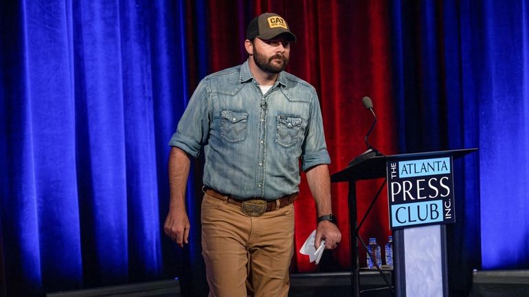 Georgia Republican Chuck Hand walks out of a debate sponsored...