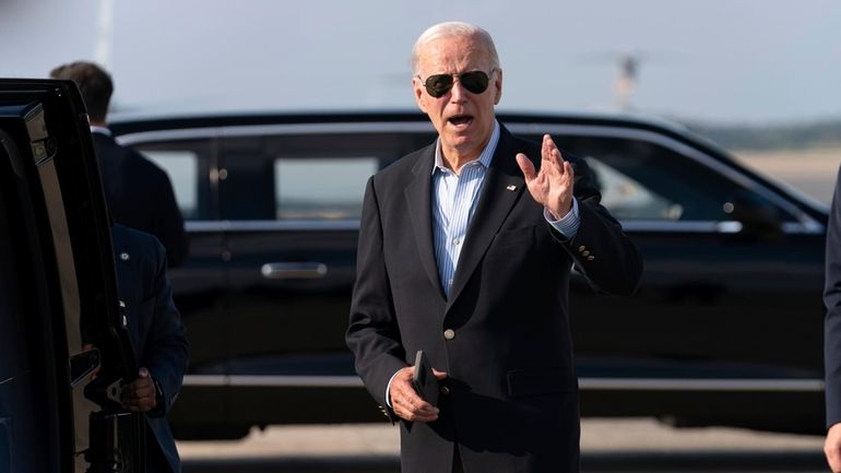 President Joe Biden talks to reporters upon his arrival to...