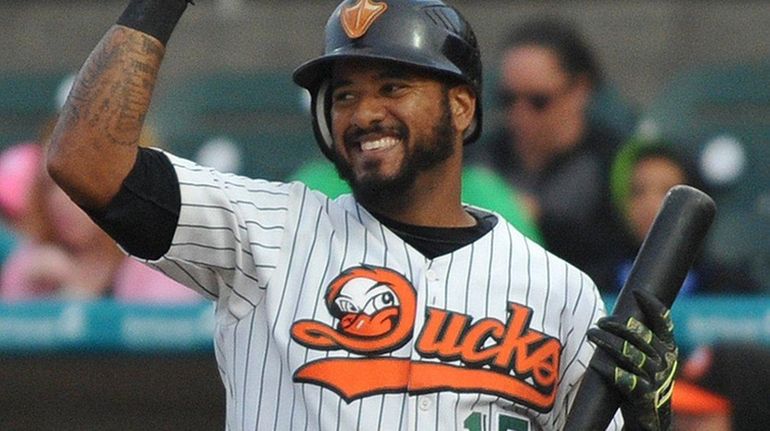 Jordany Valdespin #15 of the Long Island Ducks jokingly gestures...