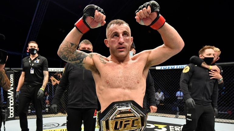 Alexander Volkanovski celebrates after his split-decision victory over Max Holloway...