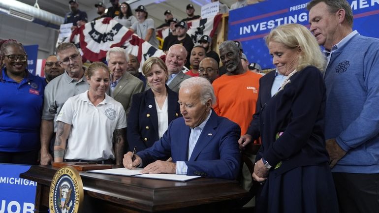 President Joe Biden participates in a signing ceremony after speaking...