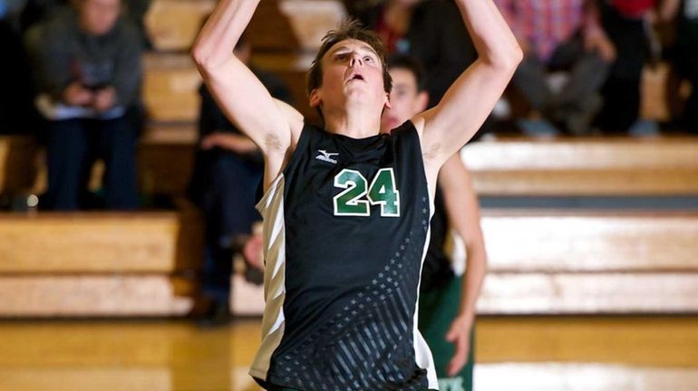 Bellmore JFK senior Gary Anderson (24) sets the ball in...