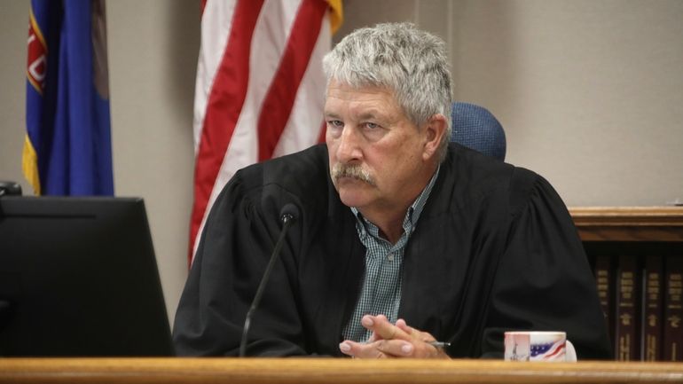 South Central District Judge Bruce Romanick listens to arguments by...