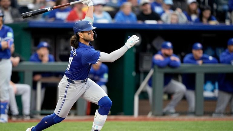 Toronto Blue Jays' Bo Bichette watches his three-run triple during...