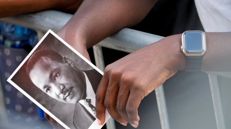 A person holds an image of the Rev. Martin Luther...