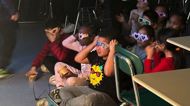 Second-grade student Jose Byrd (black t-shirt with sun) and classmates...