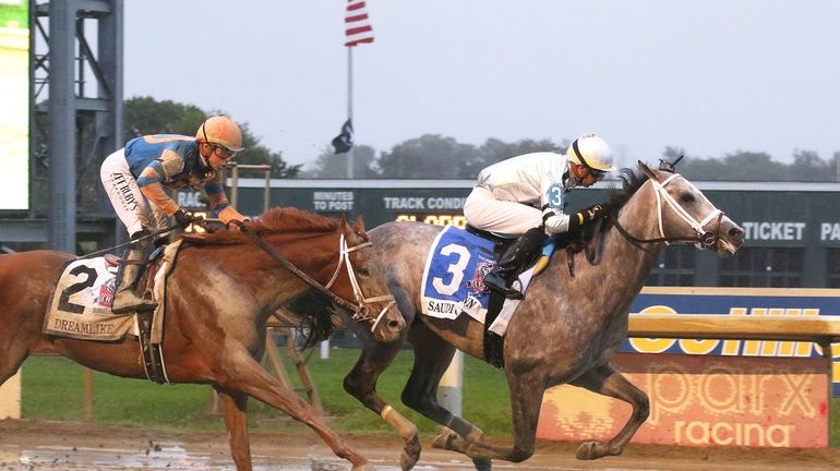 In this image provided by Equi-Photo, Saudi Crown, right, ridden...