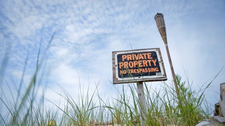 A sign indicating private property is posted at Asharoken Beach...