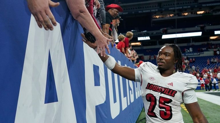 Louisville running back Jawhar Jordan greets fans after an NCAA...