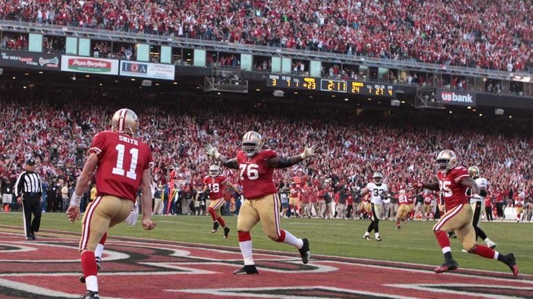 Alex Smith #11 of the San Francisco 49ers celebrates his...