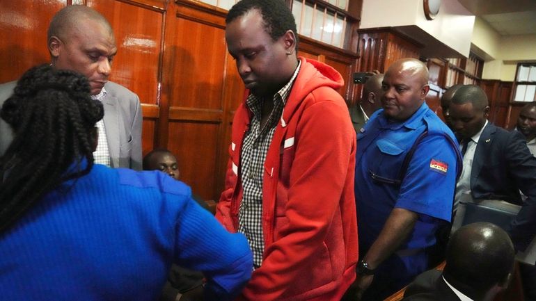 Kevin Adam Kinyanjui Kangethe is escorted out of the courtroom...