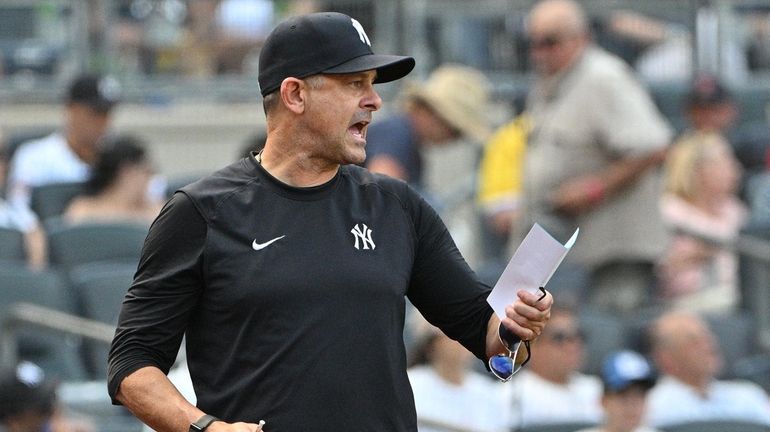 Yankees manager Aaron Boone talks to umpire Fieldin Culbreth during...