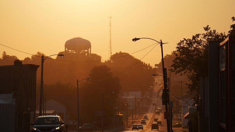 The sun rises over the city of Springfield, Ohio, Monday,...