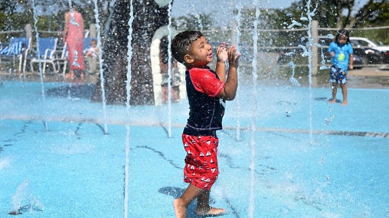 Jaxon Thomas, 2, of St. James, cools off at Tanner...