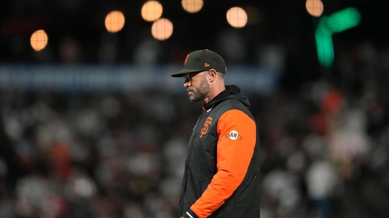 San Francisco Giants manager Gabe Kapler walks to the dugout...