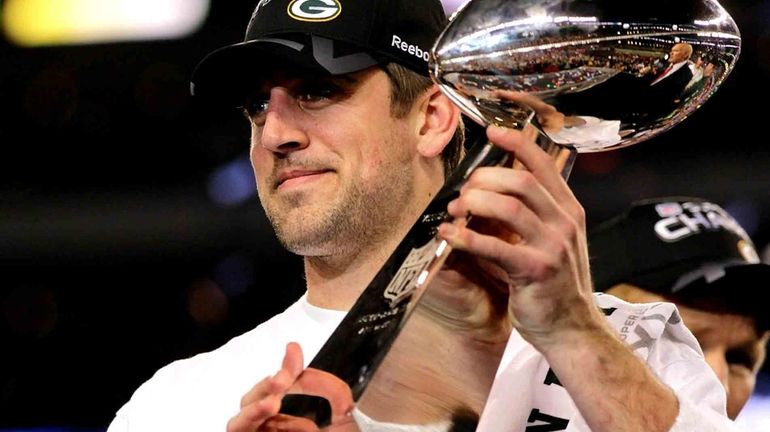 Aaron Rodgers of the Green Bay Packers holds up The...