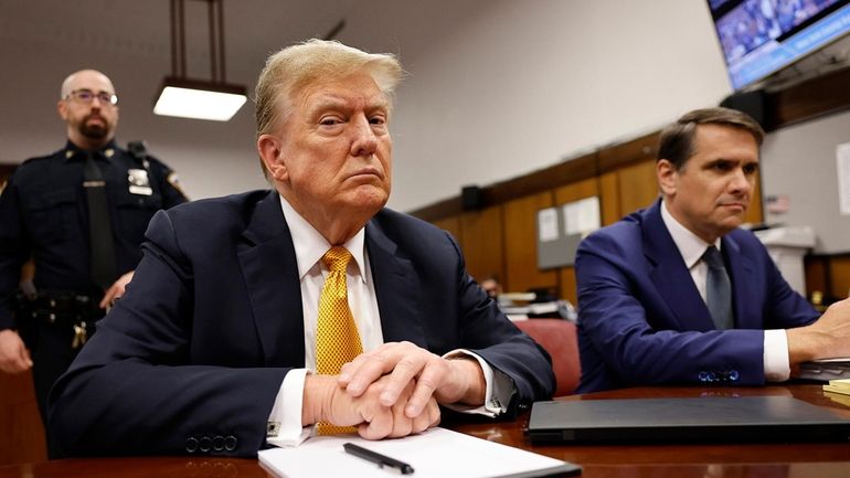 Former President Donald Trump sits in the courtroom for his...