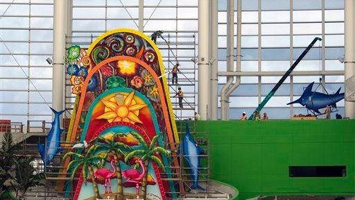 Workers install the new mechanized sculpture in center field that...