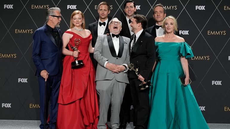 The cast of "Succession" celebrates its outstanding dramatic series win...