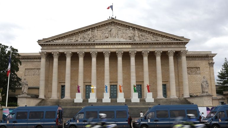 Police vans park outside the National Assembly during the second...