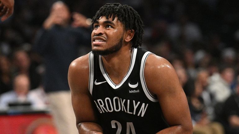 Nets guard Cam Thomas reacts during the first half of...