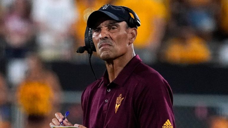 Arizona State coach Herm Edwards looks toward the scoreboard with...