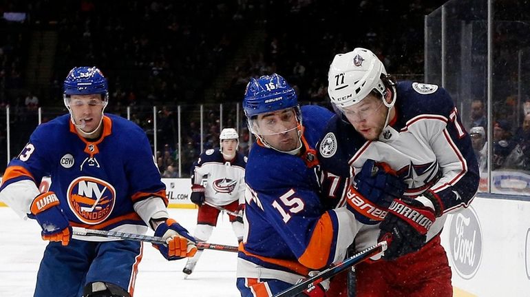 Cal Clutterbuck #15 of the New York Islanders defends against...